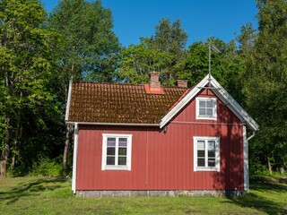 Swedish red cottage. Traditional wooden house with white corners