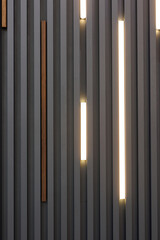 Decorative wooden partition for the interior with LED lamps. Wooden slatted panels.