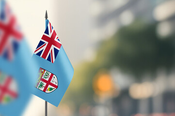 Small flags of Fiji on a blurred background