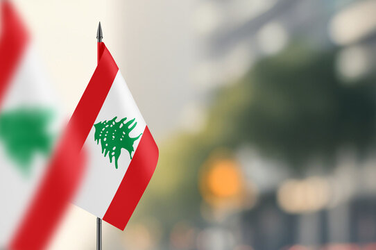 Small flags of Lebanon on a blurred background - Powered by Adobe