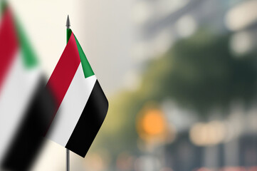Small flags of Sudan on a blurred background