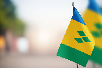Small flags of Saint Vincent on a blurred background