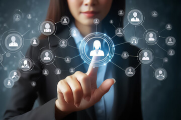 Obraz premium Business woman touching virtual icon customers of social network on blue screen