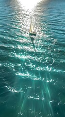 Obraz premium Sailing Boat on Sparkling Ocean Waters