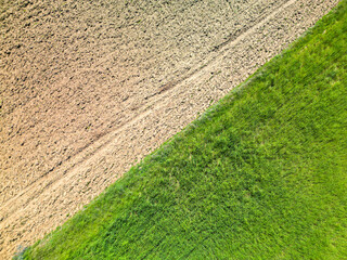Aerial view of half cultivated and half empty field