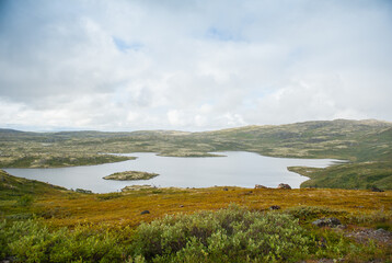 Tranquil lake nestled in a remote wilderness, offering a serene and picturesque landscape of tundra