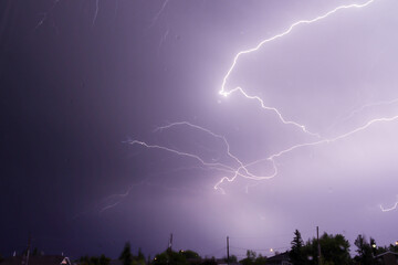 Intense Thunderstorm With Beautiful Purple Hue Lightning Bolts Taken Through Window With Raindrops...