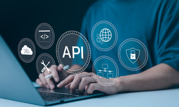 API Application Programming Interface Concept. A programmer types on a laptop, interacting with digital icons representing API development, security, and cloud computing. Application Software Tool,
