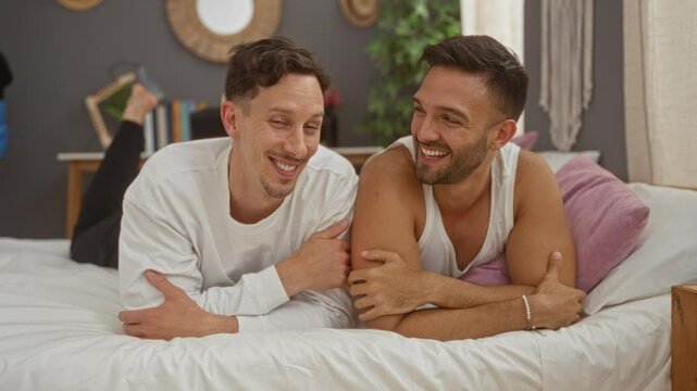 Happy gay couple relaxing on bed in cozy bedroom with smiles and love, capturing a warm and intimate moment indoors