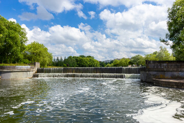 Lake in a European city. Small lake, green grass and trees
