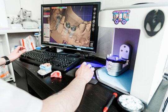 Dental technician working on a computer