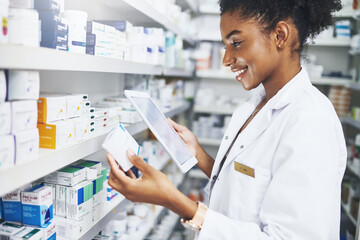 Black woman, tablet and pharmacist check medicine for stock, inventory or reading label on box at...