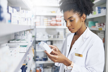 Black woman, pharmacist and medicine box in clinic for product stock, ingredients and check...