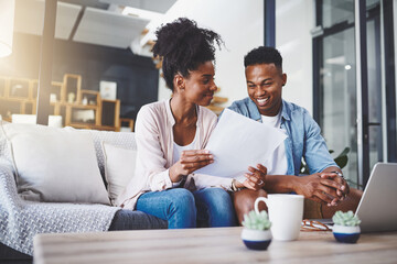 Finance, laptop and couple with documents on sofa for bills, life insurance or mortgage. Lens...