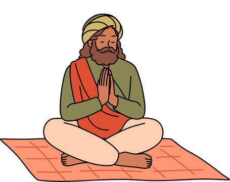 Meditating Indian man fakir prays sitting on mat with mandala sign behind back. Meditating adult guru with beard makes prayer gesture, performing esoteric and spiritualistic practices