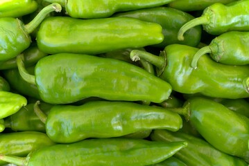 Green peppers in a box at the market.
