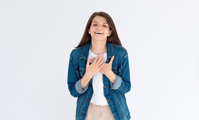 Hilarious joke. Portrait of happy optimistic girl with long hair in white shirt holding belly and laughing out loud, amused by silly funny anecdote