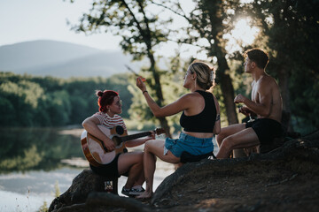 Friends enjoying music and conversation in nature on a summer day by the lake. A peaceful ambiance and scenic surroundings enhance their outdoor gathering.