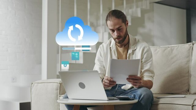 Caucasian man uploading data to cloud from living room