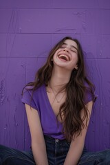 Fototapeta premium Young woman sitting outdoors laughing
