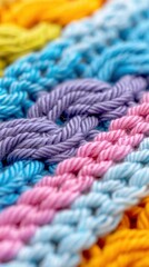 Closeup of rainbow colored knitted fabric, symbolizing diversity and strength in the LGBTQ