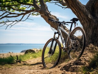 Fototapeta premium Tranquil Bike Ride - Bicycle leaned against tree on scenic trail background in serene nature setting