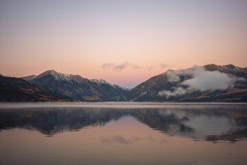 Mountains reflecting in an alpine lake in Colorado in the fall