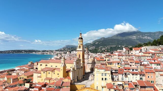 A stunning aerial view of colorful houses in Menton, France, captured by a drone on a sunny day. This video showcases the picturesque C&ocirc;te d'Azur town with charming architecture and blue sea.