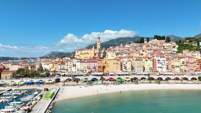 A stunning aerial view of colorful houses in Menton, France, captured by a drone on a sunny day. This video showcases the picturesque C&ocirc;te d'Azur town with charming architecture and blue sea.