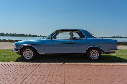 Side view of Mercedes-Benz C123 (w123 coupe) 230CE (benzin (petrol), injector 2.3l 1980-1985) in blue color. Palic, Serbia, 08.06.2024