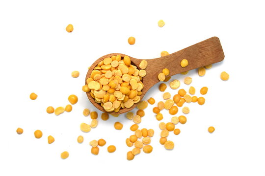 Toor dal or split yellow lentils in a wooden spoon isolated. Split Chickpea in a Bag Also Know as Chana Dal, Yellow Chana Split Peas, Dried Chickpea Lentils or Toor Dal isolated on white Background