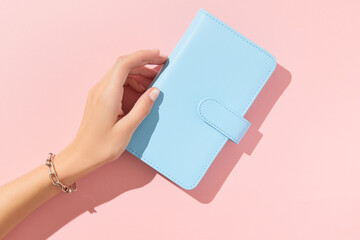 Womans hand with trendy nude manicure on pink background. Summer nail design