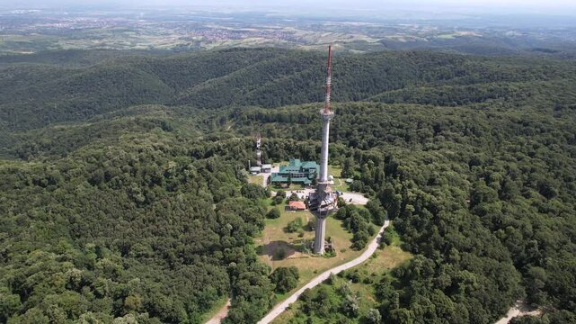 Orbital aerial shot of Irishki Venac Tower in Frushka Gora national park on sunny summer day. Serbia.
