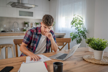 Young caucasian man teenager student study at home