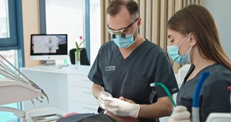 Dentist and Assistant Conducting Dental Procedure in Modern Clinic