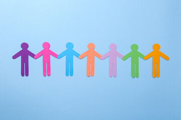 Equality concept. Different human figures on light blue background, flat lay