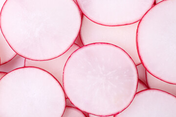 Slices of fresh ripe radish as background, top view