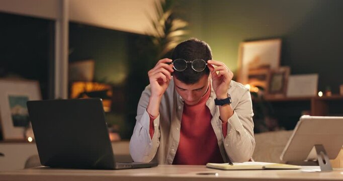 Student, man and tired in home at night with exam stress, university anxiety and overworked at desk. Person, technology and eye strain with headache or burnout for learning, education and scholarship