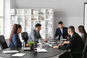 Business people negotiating at table in conference hall