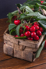 ripe cherries on branches in a box on the table close up