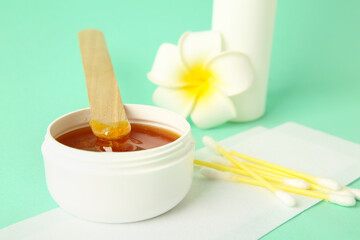 Composition with sugaring paste on turquoise background. Epilation concept