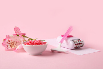 Electric epilator, razor, wax and flower on pink background. Hair removal concept