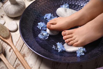 Young woman undergoing spa pedicure in beauty salon, closeup