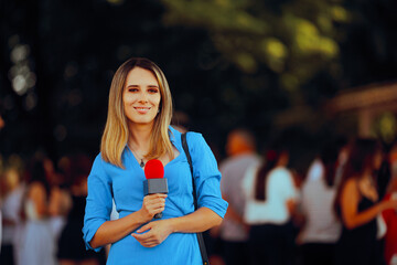 Reporter Holding a Microphone in Outdoors Broadcasting Event. Happy professional journalist...