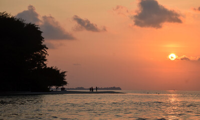 Tourists are enjoying the beauty of the beach when the sun is setting, with stunning natural beauty on Menjangan Island, Karimunjawa Islands, Central Java, Indonesia