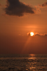 The sun looks like the moon before setting on the western horizon, has beauty with a dazzling orange light color