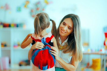 Happy Mother Leaving her Little Kid at the Kindergarten. Moms saying goodbye when girl goes back to school
