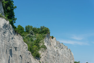 view of Scarborough Bluffs, an escarpment, viewed from the bottom of Scarborough Heights Park (27 Fishleigh Drive) accessed via a service road with pathways to the shoreline trail