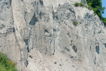 view of Scarborough Bluffs, an escarpment, viewed from the bottom of Scarborough Heights Park (27 Fishleigh Drive) accessed via a service road with pathways to the shoreline trail