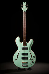 Obraz premium Elegant Sea-Green Bass Guitar in Focus: A Striking Statement of Musicality and Performance